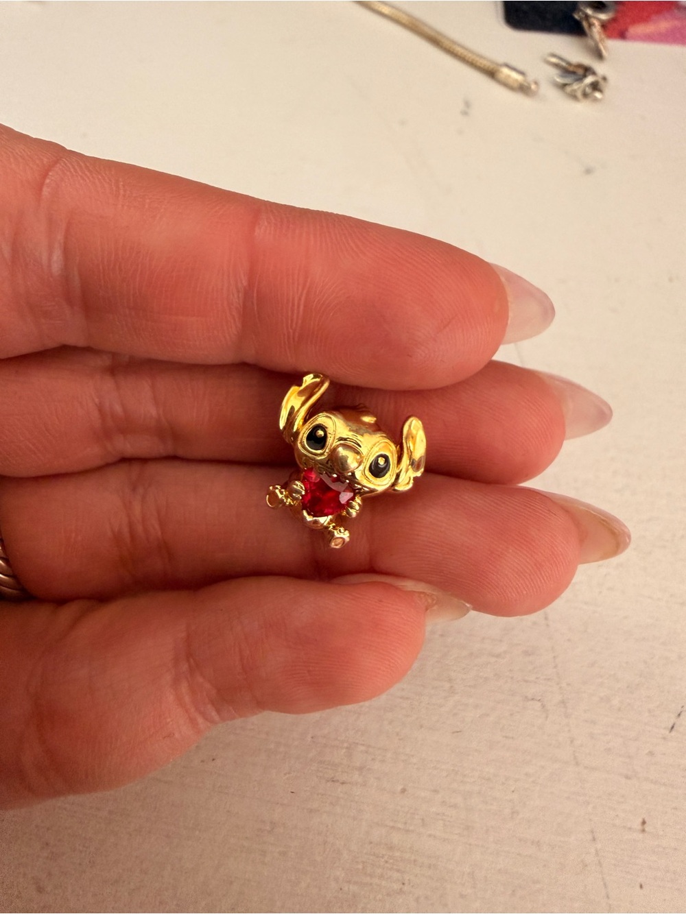 Pandora Gold Stitch Charm with Red Accent